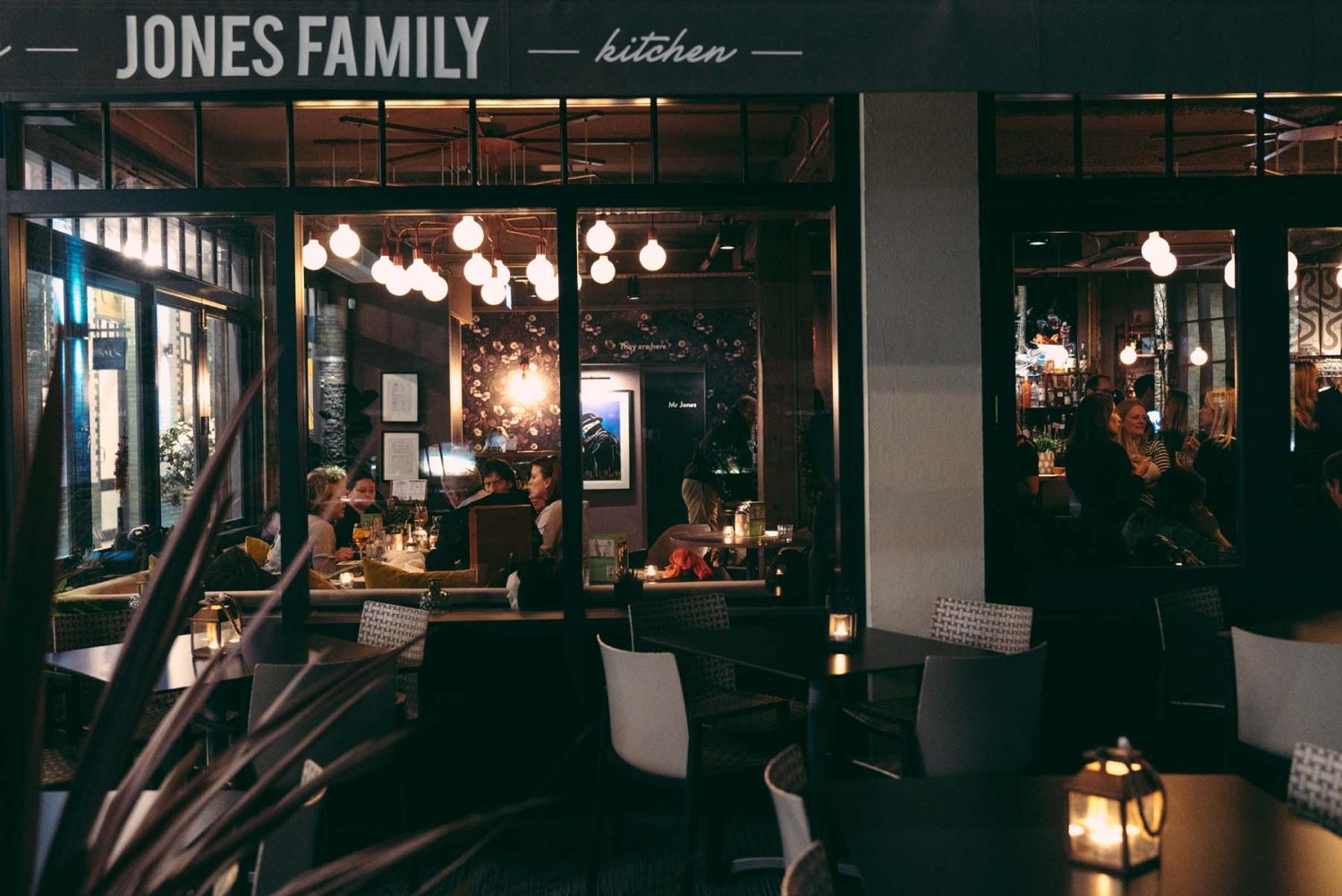 The warmly lit bar and dining room at The Jones Family Kitchen.